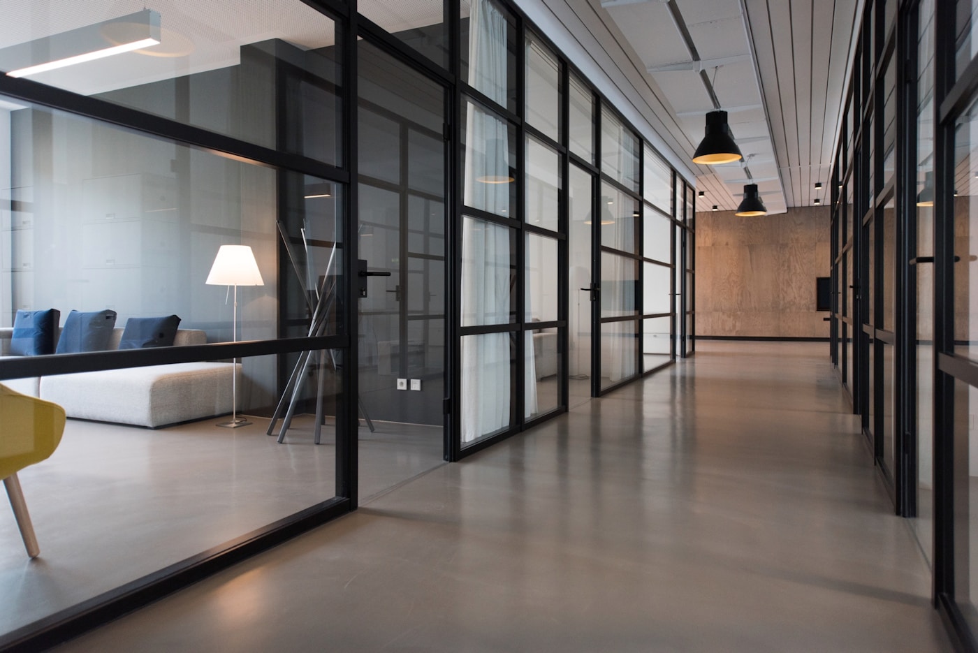 Contemporary corporate office with glass, stone and warm lighting